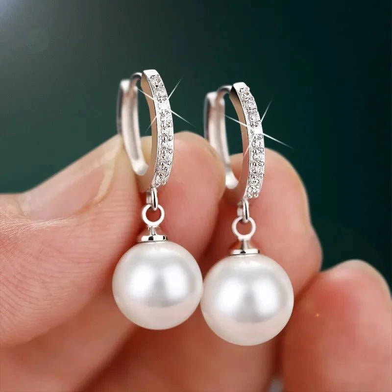 Sterling Silver Pearls EarringsDescription: These elegant drop earrings are a testament to exquisite craftsmanship and timeless beauty. Designed with meticulous attention to detail, they are the pSHOP ALL I WANTShop All I WantSterling Silver Pearls Earrings
